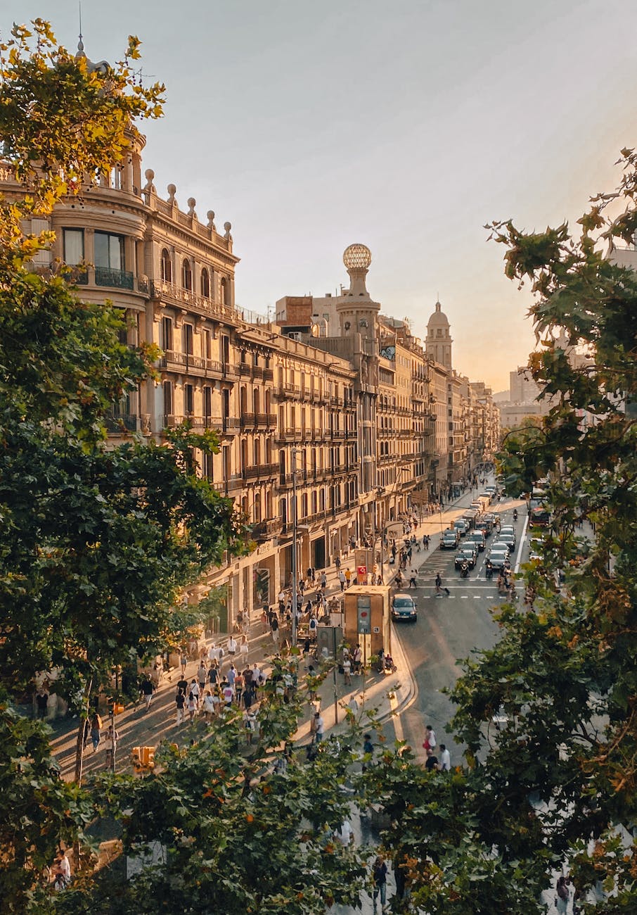 A golden-hour street view in Barcelona's Eixample district — the Haussmann-style architectural language most premium Barcelona aparthotels inhabit.