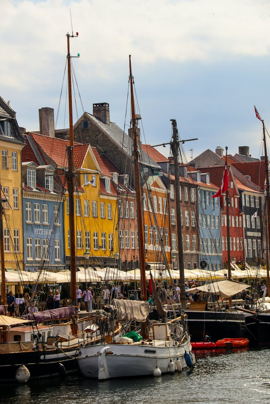 Copenhagen's Nyhavn harbour with the painted 17th-century townhouses — the visual signature that anchors the Indre By neighborhood.